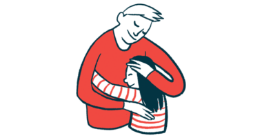 A man and a child share a hug.
