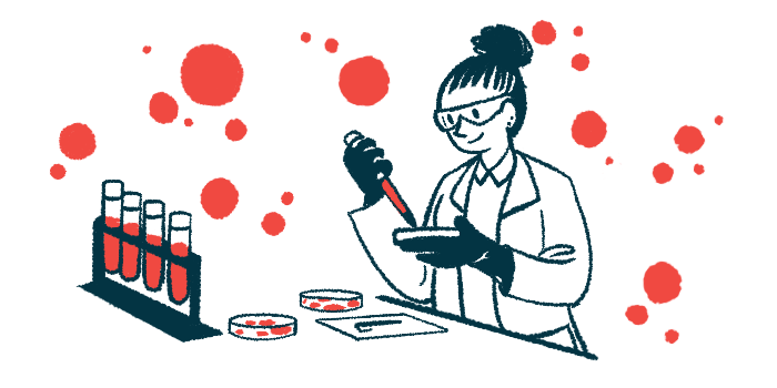 A scientist holds a dropper filled with red liquid next to a petri dish.