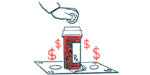A hand drops a coin into a prescription medication bottle that stands on a stack of bills.