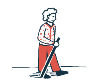 An elderly woman walks with a walking stick.